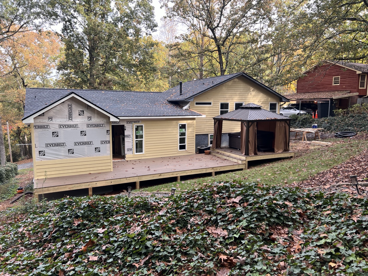 Exterior renovation featuring a new deck and home addition