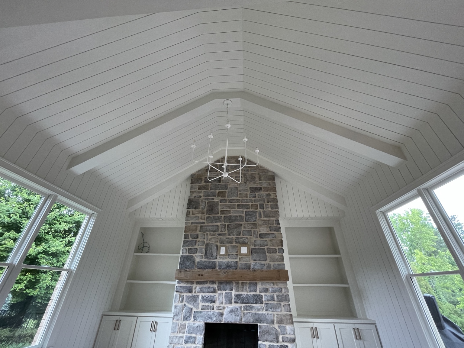 Stone fireplace great room completed by Wave Renovation