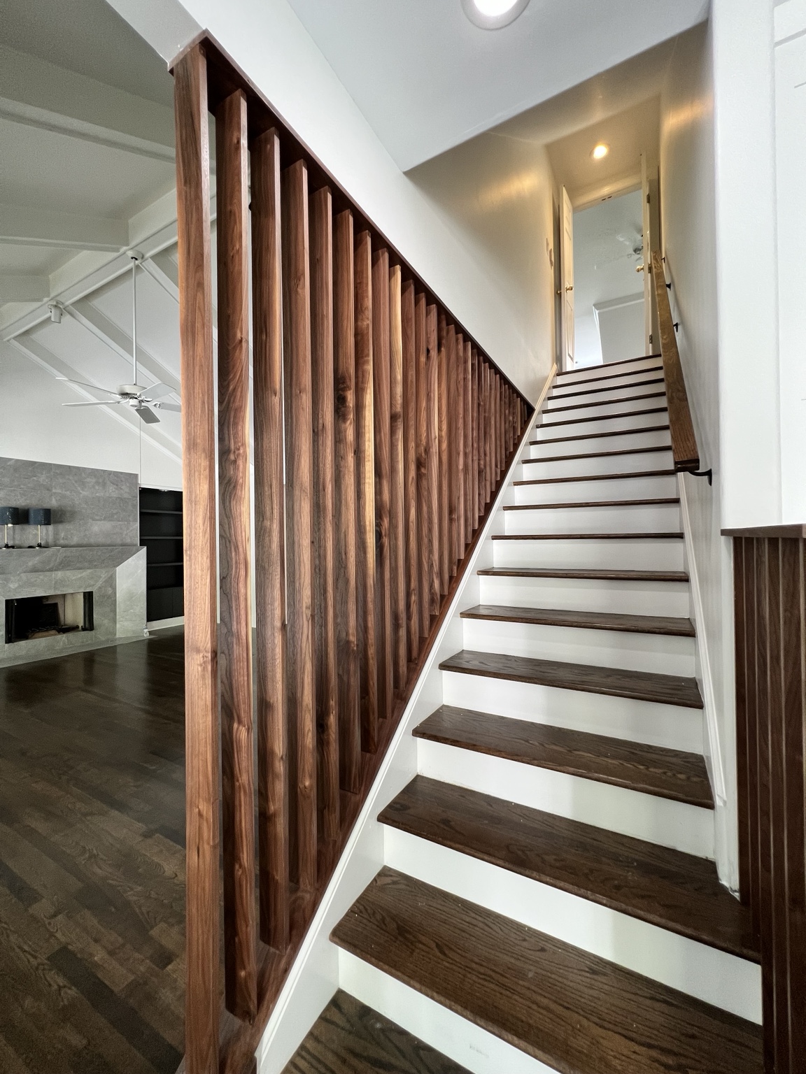 Walnut slat stair wall completed by Wave Renovation