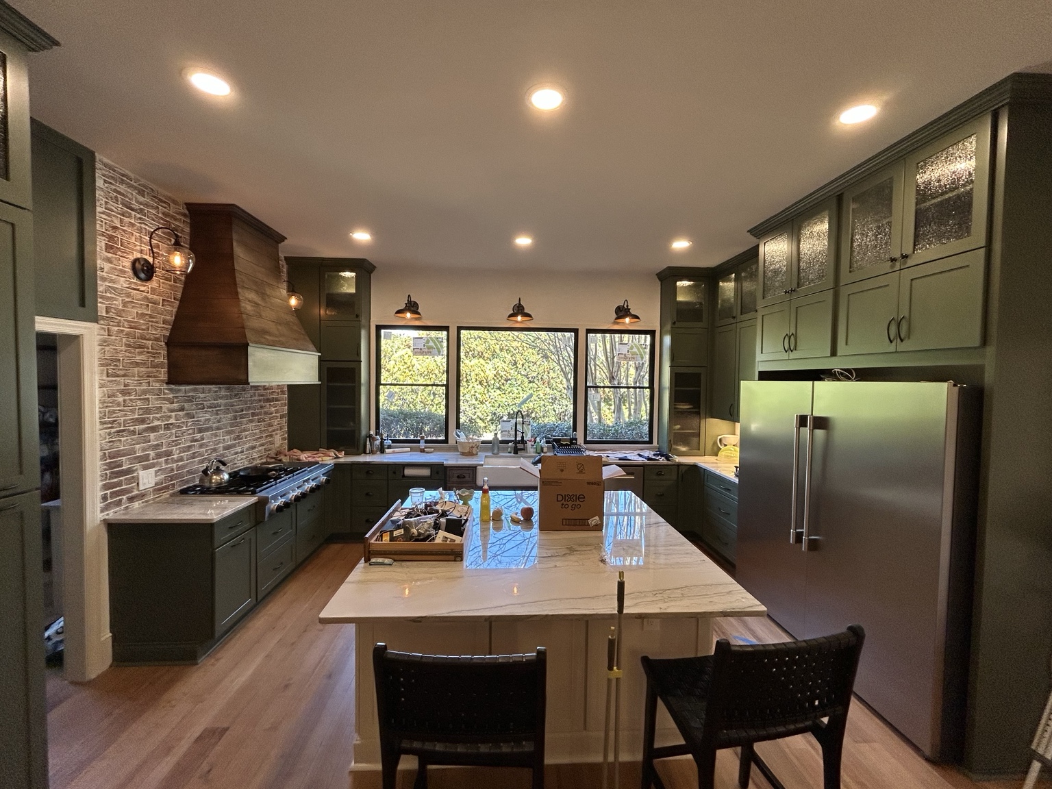 Custom green cabinetry completed by Wave Renovation
